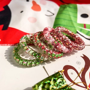 Detailed view of Christmas spiral hair ties with festive patterns and holiday colors