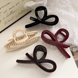 Set of four glossy hollow hair claws in black, cream, burgundy and coffee brown tones