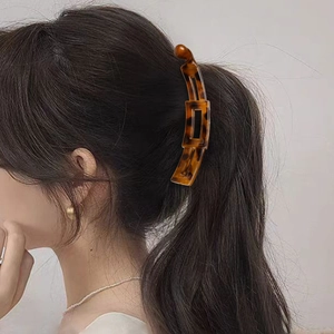 Amber tortoiseshell banana hair clip for women showing stylish vertical hairstyle