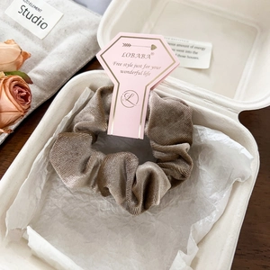 Champagne velvet scrunchie in elegant gift box packaging with dried roses