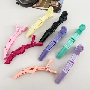 Flat lay of eight colorful professional alligator hair clips for styling and sectioning