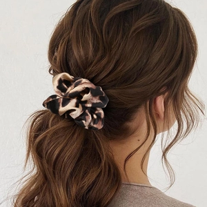 Elegant leopard print silk satin scrunchie for women styling ponytails and hair buns