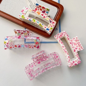 Detail view of 4-pack large square heart print hair claws in various sweet patterns