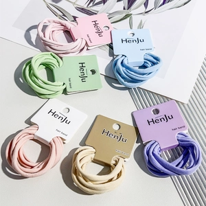 Detailed close-up of six elastic hair bands in soft candy colors on display cards