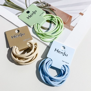 Detail view of 6-pack high elasticity seamless hair bands in green, brown and blue colors