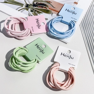 Close-up of four packs of seamless elastic hair bands in pastel candy colors with card