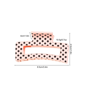 Pink hair claw clip with black polka dots and size measurements in a clean layout