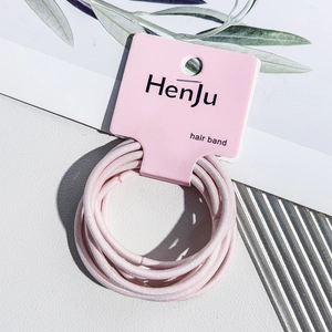 Close-up of pink high-elastic hair bands on a premium card set against a stylish background