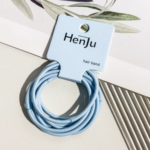 Detail view of light blue seamless high elasticity hair bands on branded paper card