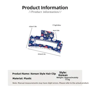 Detail view showing blue floral daisy print shark hair clip with specific dimensions