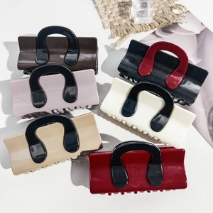 Collection of six large glossy hair claws in mixed colors including burgundy and cream
