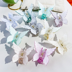 Detailed macro view of 10-piece multi-color acrylic butterfly hair claws with metal springs