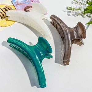 Three-piece large glossy hair claws in cream, brown, and emerald green colors