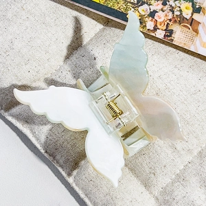 Detail view of the iridescent butterfly hair claw with a durable gold metal spring