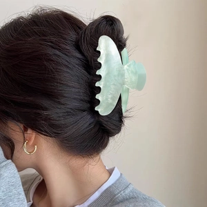 Mint green butterfly hair claw clip with pearlescent marble texture for women
