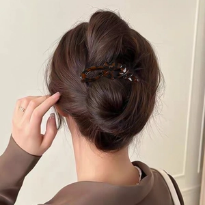 Glossy butterfly hair clip with tortoiseshell pattern on an elegant bun hairstyle