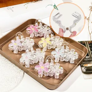 Floral acrylic hair claws with hand-painted graffiti design on vintage tray