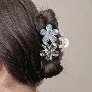 Floral graffiti hair claw clip with blue petals and white flowers for bun hairstyles