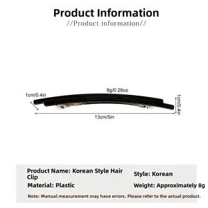 Macro detail of a 13cm black minimalist oval hair clip with silver metal spring mechanism