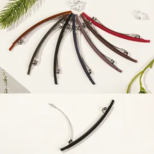 Minimalist spring hair clips in various matte colors shown in fan layout and open view