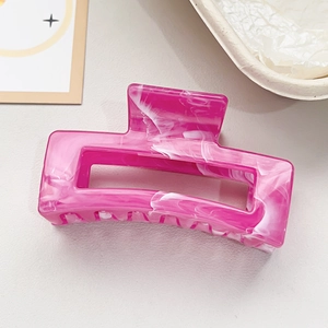 Detail view of large rectangular hair claw clip with pink marble texture pattern