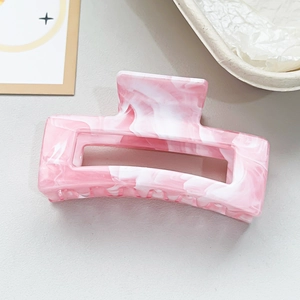 Detail of pink marble textured square hair claw clip made of premium acrylic material