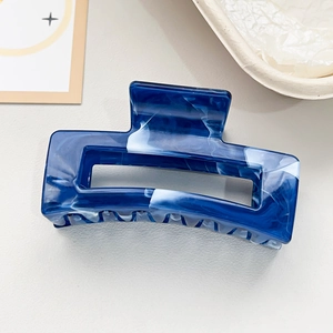 Detail of blue marble texture rectangular hair claw clip made of acetate material
