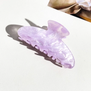 Detail of light purple marble pattern acrylic hair claw clip for elegant hairstyles
