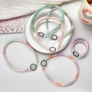 Detailed macro view of colorful gradient telephone wire hair coils in pastel macaron shades