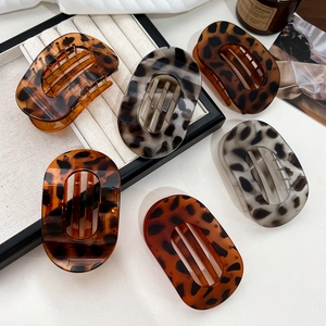 Set of 6 leopard and tortoise shell oval claw clips on an elegant jewelry tray