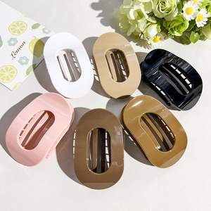 Detailed top view of 6-piece oval hair claw clip set in various earth tones on light background