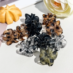 Detailed arrangement of 2.5cm frangipani flower hair claws in multiple assorted colors