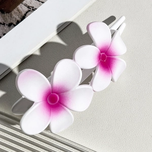 Detail view of sweet gradient flower hair clip with white petals and pink center accents