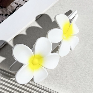Detailed close-up of double frangipani hair clip with yellow gradient flower petals