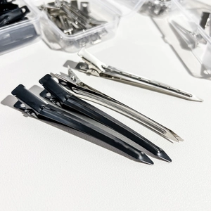 Detail of professional black and silver metal styling hair clips for salon partitioning