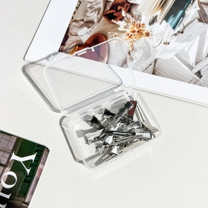 Set of silver metal hair clips in a transparent storage box with a modern aesthetic display