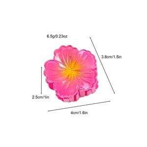 Pink resin flower hair claw clip with yellow center for summer beach vacation style