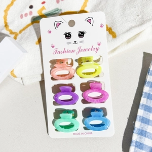 Detailed set of 6 colorful acrylic mini hair claws on a cute illustrated display card
