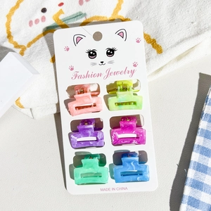 Set of six mini marble texture hair claws in vibrant colors displayed on a cat illust card