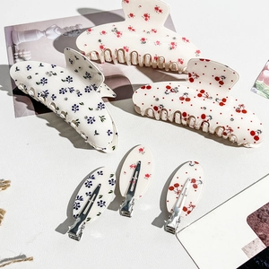 Floral hair clip set featuring blue blossoms and cherry patterns with small rhinestones