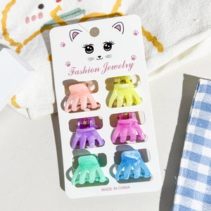 Close-up of 6 colorful marble texture mini hair claws on a cute cat-themed display card