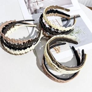 Close-up of matte resin wavy headbands with anti-slip teeth in Morandi earth tones