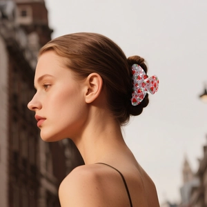 Pince à cheveux blanche avec imprimé fraise pour femme portée par un mannequin