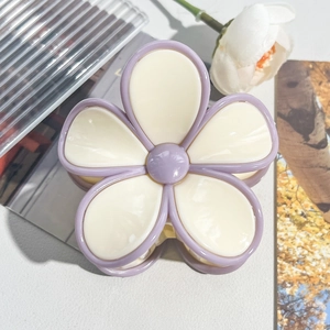 Close-up of lavender and cream flower hair claw clip with glossy acrylic finish