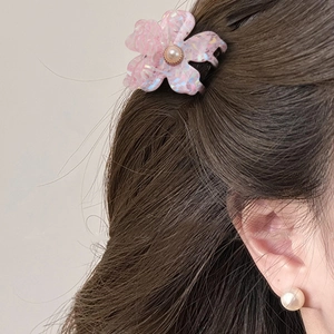 Pink floral hair claw clip and pearl earrings set shown on a model for hair styling