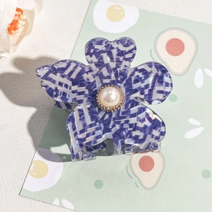 Detail of flower hair claw clip with purple tweed pattern and center pearl ornament
