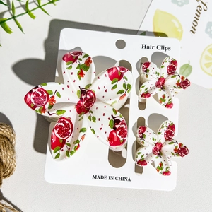 Three-piece hair clip set with realistic pomegranate prints on white floral shark clips