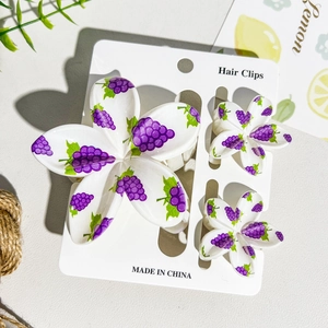 Detailed set of three UV printed floral hair clips with purple grape and leaf patterns