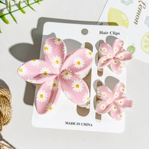 Detailed set of UV printed pink daisy hair clips and shark claw for summer seaside styles