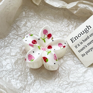 Detailed close-up of a frangipani hair claw clip with cherry and strawberry UV printing